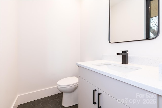 bathroom with vanity, tile patterned floors, and toilet