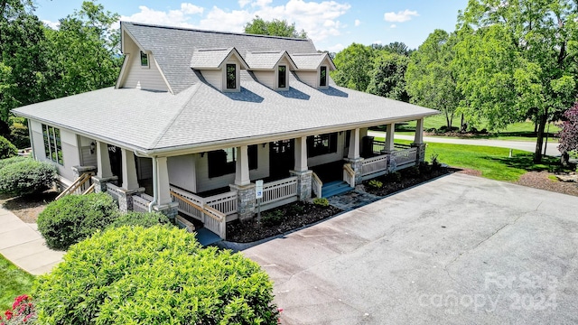 view of front of house featuring covered porch and a front yard