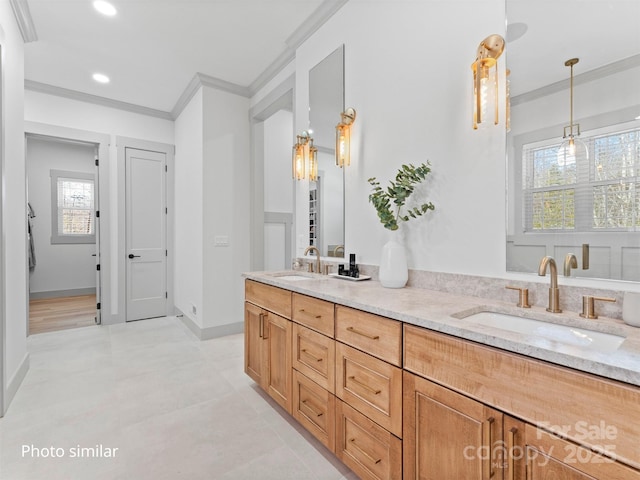 bathroom featuring ornamental molding, a sink, and double vanity