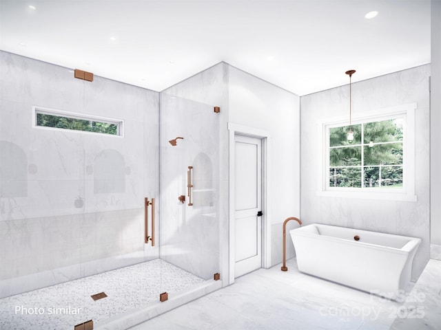 bathroom with a stall shower, marble finish floor, and a soaking tub