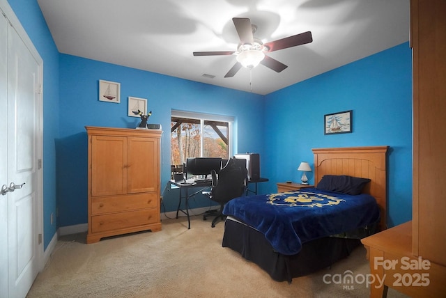 carpeted bedroom with a closet and ceiling fan