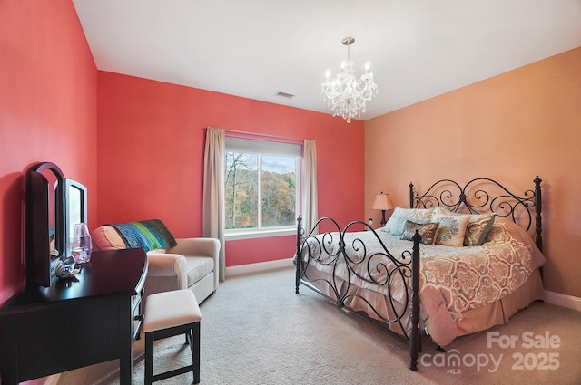 bedroom featuring light colored carpet and an inviting chandelier