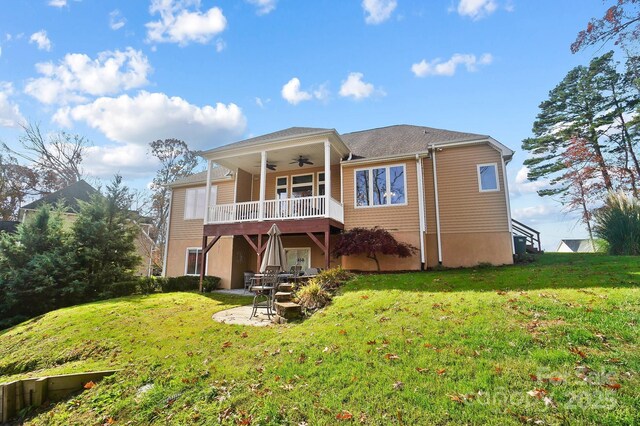 back of property featuring ceiling fan, a yard, and a wooden deck