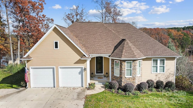 view of front of house with a front yard and a garage