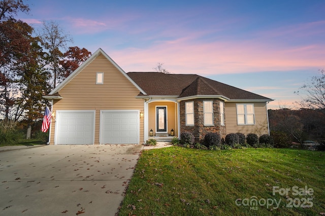 view of front of property featuring a yard and a garage