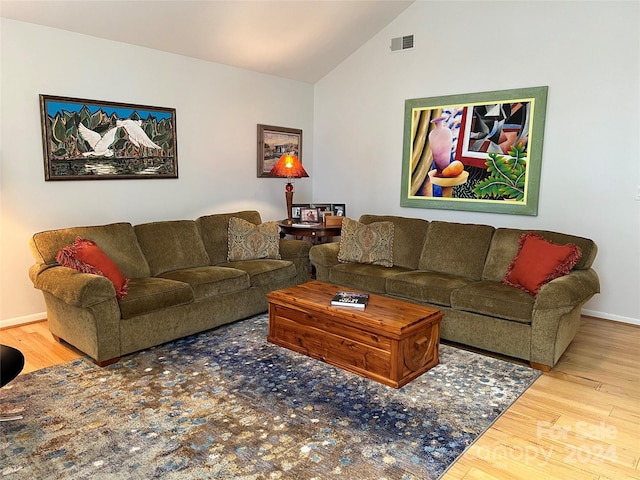 living room featuring hardwood / wood-style flooring and high vaulted ceiling