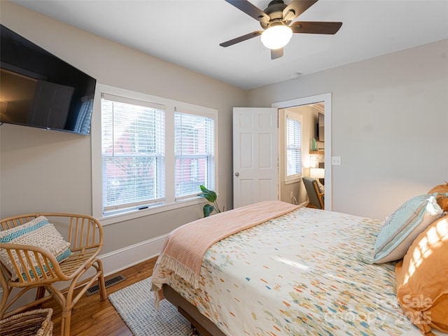 bedroom with wood-type flooring and ceiling fan