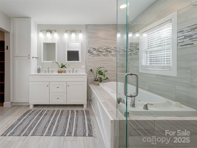 bathroom featuring vanity and separate shower and tub