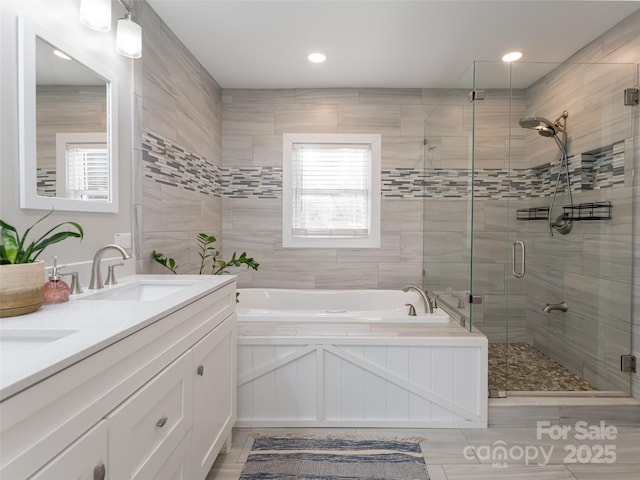 bathroom featuring shower with separate bathtub and vanity