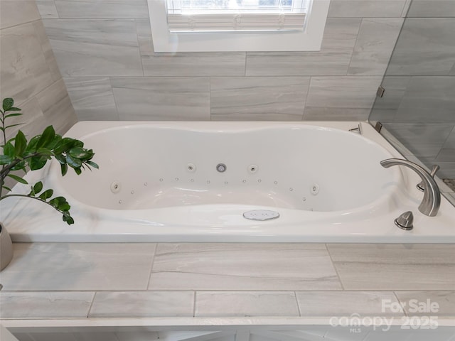 bathroom with a relaxing tiled tub