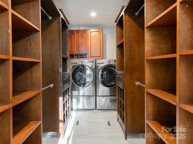 laundry room with cabinets and washer and clothes dryer