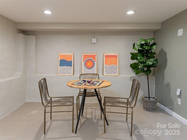 dining area featuring concrete flooring