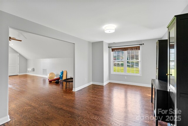 interior space with dark wood-type flooring and baseboards