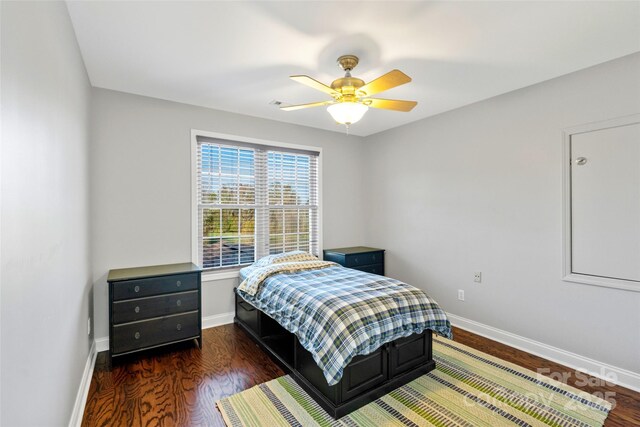 bedroom featuring ceiling fan, baseboards, and wood finished floors