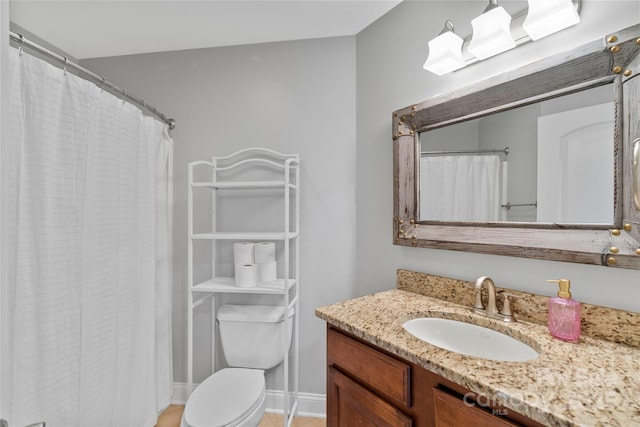 bathroom with toilet, curtained shower, and vanity