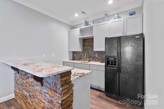 kitchen featuring a sink, visible vents, dark wood-style floors, open shelves, and black refrigerator with ice dispenser