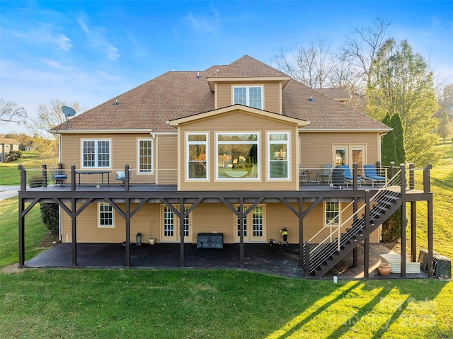 back of house featuring a deck, a shingled roof, stairway, a lawn, and a patio area