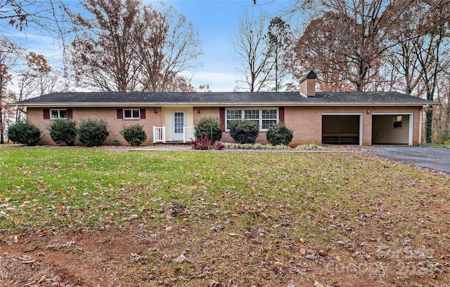 ranch-style home with a garage and a front lawn