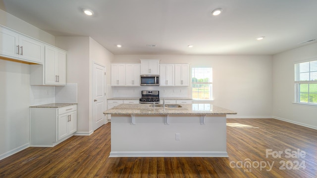 kitchen featuring dark hardwood / wood-style floors, white cabinetry, and appliances with stainless steel finishes