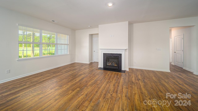 unfurnished living room with dark hardwood / wood-style flooring