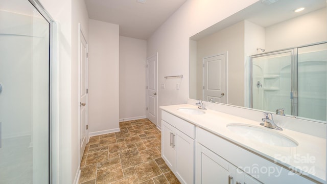 bathroom featuring vanity and a shower with door