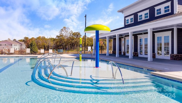 view of pool featuring french doors and a patio