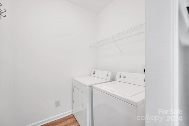 laundry room featuring light hardwood / wood-style flooring and washer and dryer