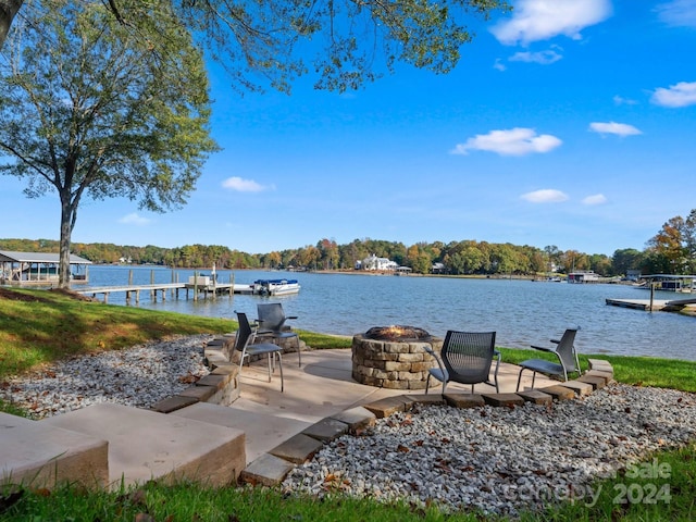 property view of water featuring a dock and a fire pit