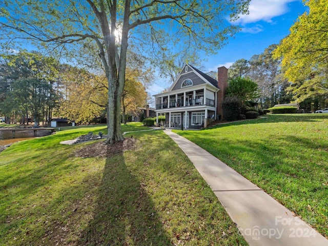 view of front of property with a front lawn and a sunroom