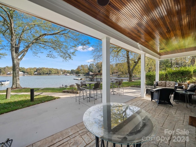 view of patio featuring an outdoor living space and a water view