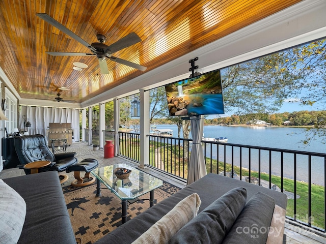 sunroom featuring ceiling fan and wood ceiling