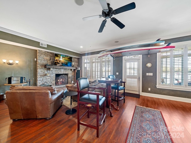 living room featuring a fireplace, dark hardwood / wood-style flooring, and ornamental molding