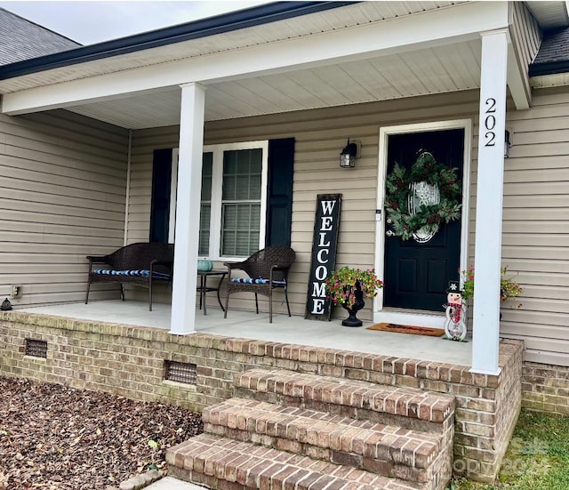 doorway to property featuring covered porch