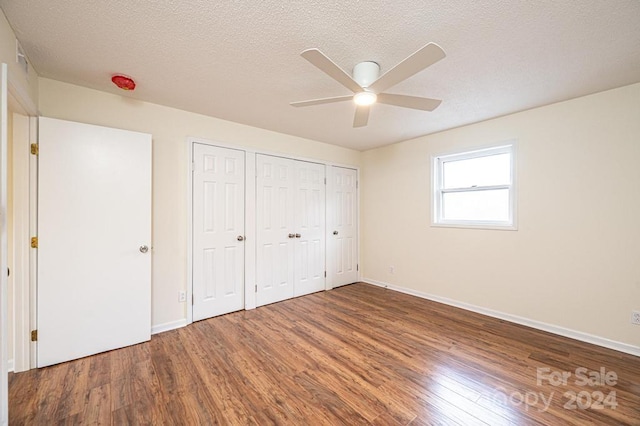 unfurnished bedroom featuring a textured ceiling, hardwood / wood-style flooring, and ceiling fan