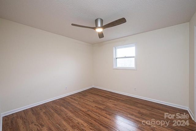 unfurnished room with a textured ceiling, ceiling fan, and dark wood-type flooring