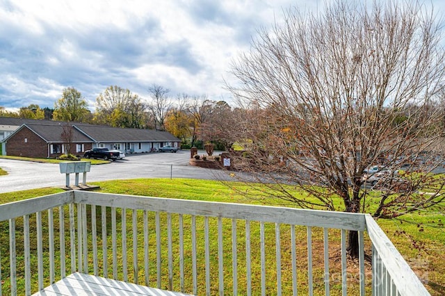 wooden deck featuring a yard