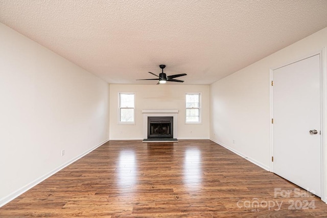 unfurnished living room featuring a textured ceiling, hardwood / wood-style flooring, and ceiling fan