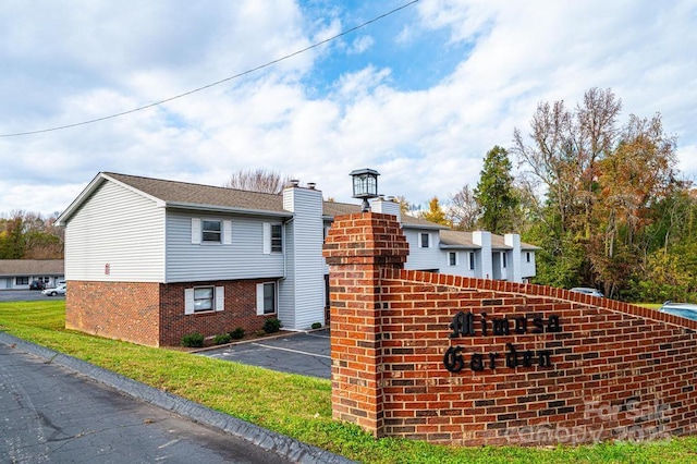 123 23rd St NW Unit E, Hickory, NC 28601 - view of side of home with uncovered parking and brick siding
