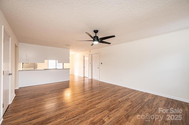 123 23rd St NW Unit E, Hickory, NC 28601 - unfurnished living room featuring dark wood finished floors, a ceiling fan, a textured ceiling, and baseboards