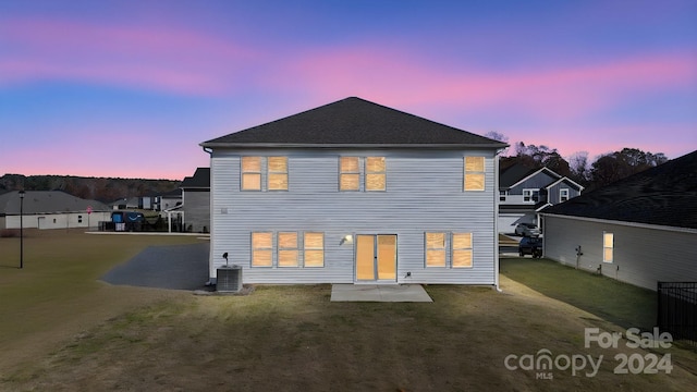 back house at dusk with central AC