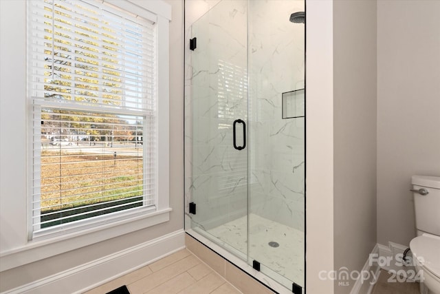 bathroom with walk in shower, tile patterned flooring, and toilet