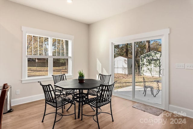 dining area with light hardwood / wood-style floors and a wealth of natural light