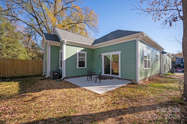 back of property with a patio area and central AC