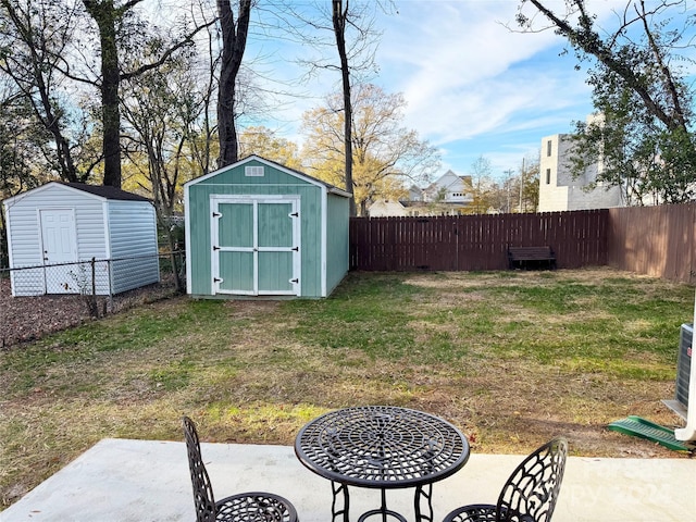 view of yard featuring a patio and a shed