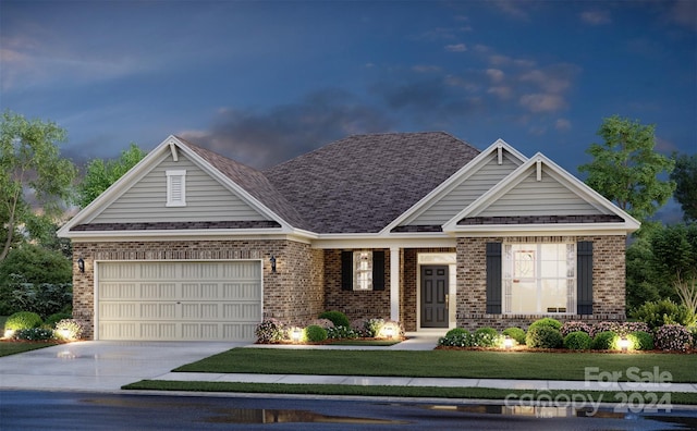 view of front of home featuring a yard and a garage