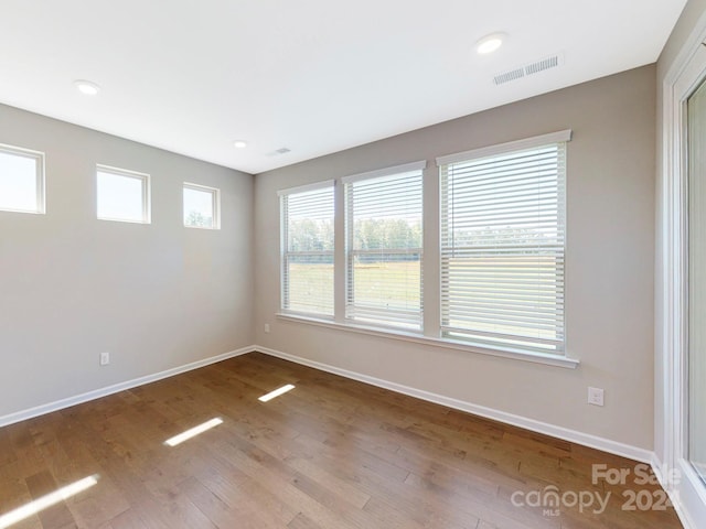 unfurnished room with light hardwood / wood-style floors