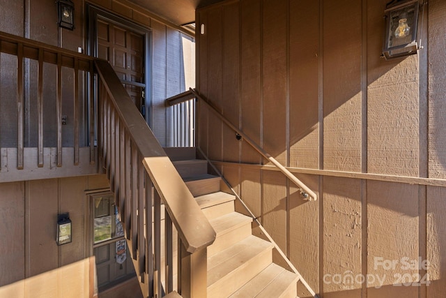 staircase with wooden walls