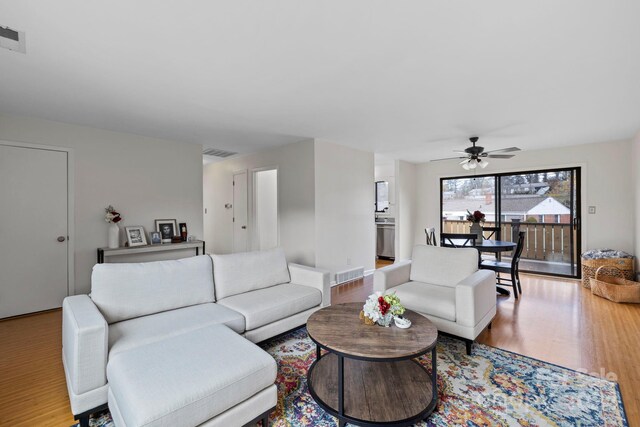 living room featuring ceiling fan and hardwood / wood-style floors