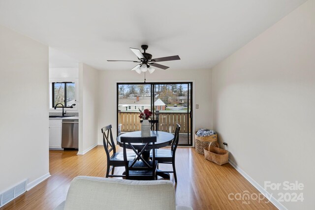 dining space featuring ceiling fan, light hardwood / wood-style flooring, and sink