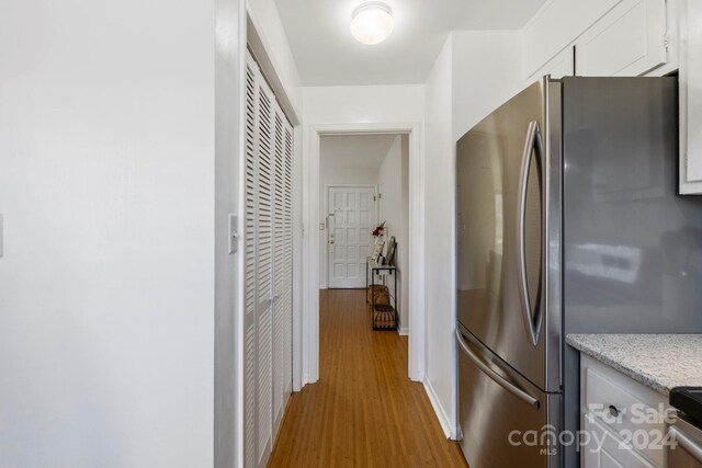 kitchen featuring white cabinetry, light wood-type flooring, and appliances with stainless steel finishes